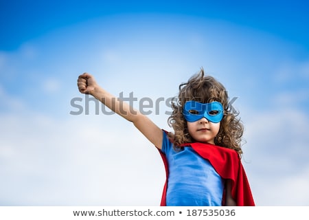 Stockfoto: Boy In Hero Costume Flying In Sky