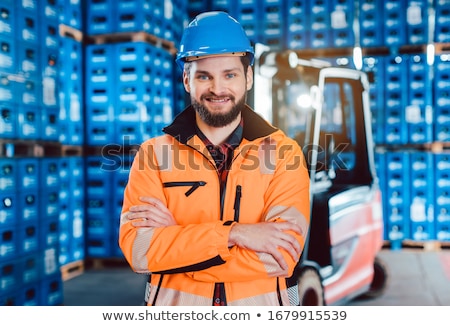 Foto stock: Worker In A Forwarding Company With His Forklift