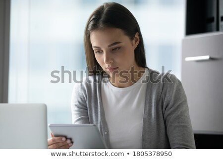 Foto stock: Young Confident Businesswoman With Touchpad Watching Online Course Or Webinar