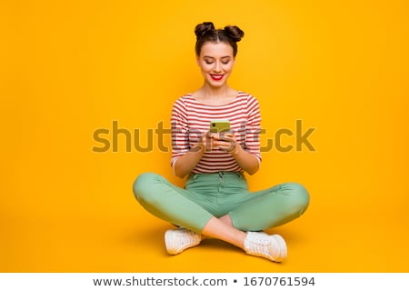 Foto stock: Attractive Young Smiling Girl Sitting On The Floor