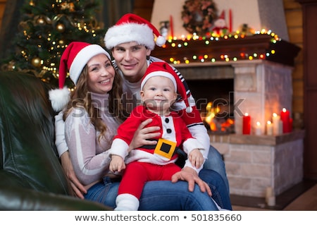 Сток-фото: Young Girl Cuddling Teddy Bear In Front Of Christmas Tree
