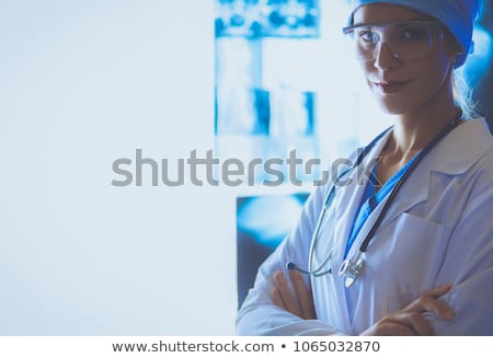 Stok fotoğraf: Image Of Attractive Woman Doctor Looking At X Ray Results