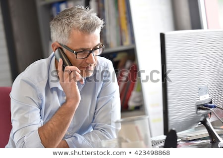 Stockfoto: European Businessman Talking On Phone At Office