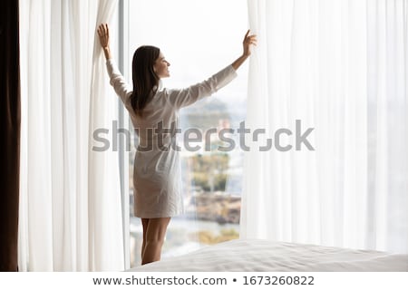 Stok fotoğraf: Pretty Woman Standing At The Window At Home