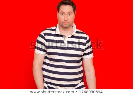 Foto d'archivio: Aggressive Man In Striped T Shirt Looking With Loathing And Show