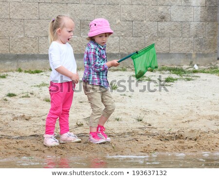 Zdjęcia stock: Cute Girl And Boy Fishing With A Net On A Lake