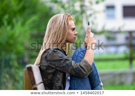 ストックフォト: Young Woman Looking At Her Tablet On Consternation