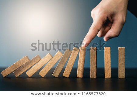 Сток-фото: Close Up Of Businessman Hand Stopping Falling Wooden Dominoes Ef