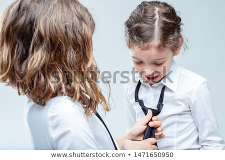 Foto stock: Older Girl Helping Her Young Sister Tie A Necktie