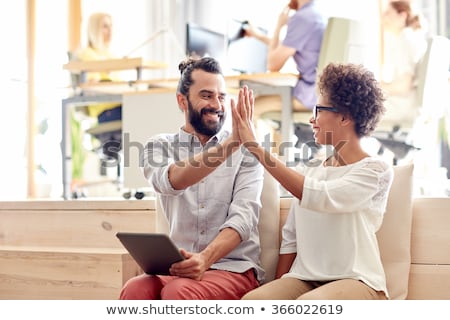 Stockfoto: Happy Creative Team Making High Five At Office