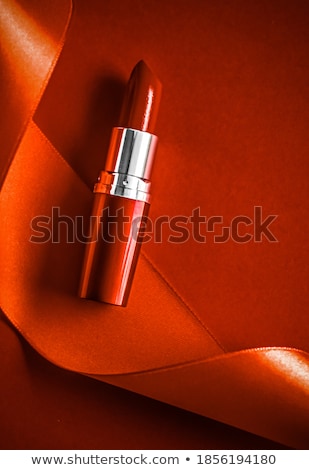 Сток-фото: Luxury Lipstick And Silk Ribbon On Orange Holiday Background Ma