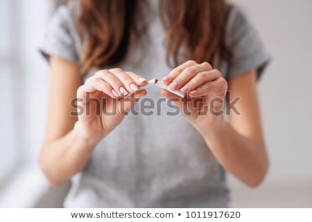 Stock photo: Portrait Of The Smiling Woman With A Cigarette
