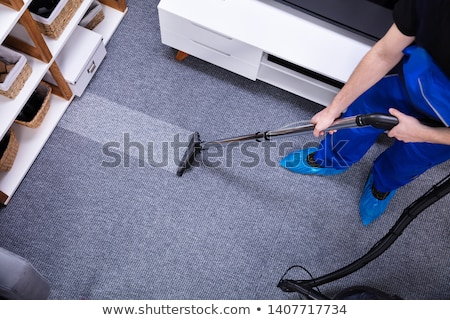 Stock fotó: Janitor Cleaning Floor With Vacuum Cleaner