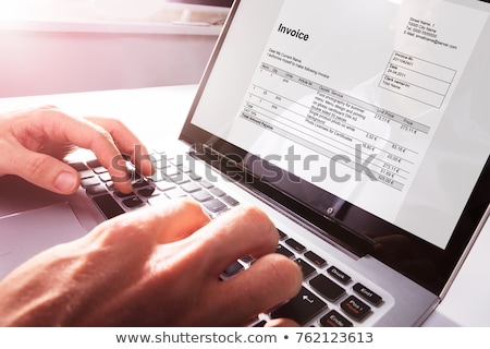 Foto stock: Businessman Checking Invoice On Laptop