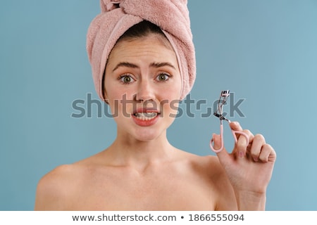 [[stock_photo]]: Confused Young Beautiful Woman Isolated Over Blue Wall Holding Citrus And Pineapple