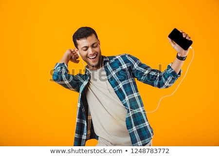 Сток-фото: Excited Young Man Wearing Plaid Shirt Standing