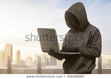 Stok fotoğraf: Anonymous Hacker Using Laptop In Darkness