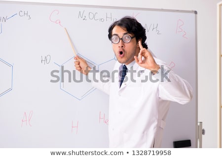 Stok fotoğraf: Young Funny Chemist In Front Of White Board