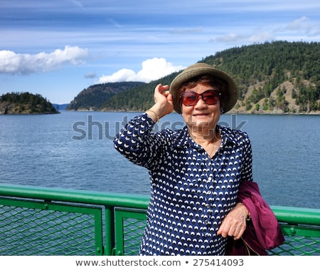 Woman Looking Up While Wearing Sun Hat And Glasses ストックフォト © tab62