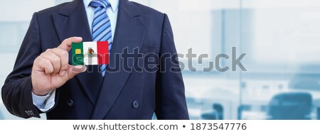 Foto stock: Mexican Businessman Holding Business Card With Mexico Flag