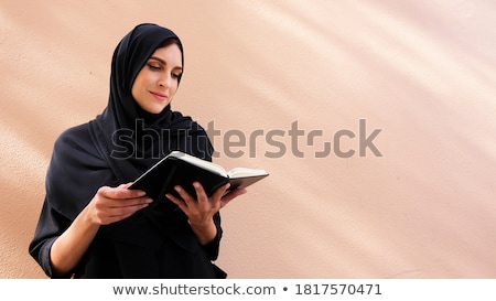 Stockfoto: Smiling Young Pretty Woman Wearing Scarf Reading Book