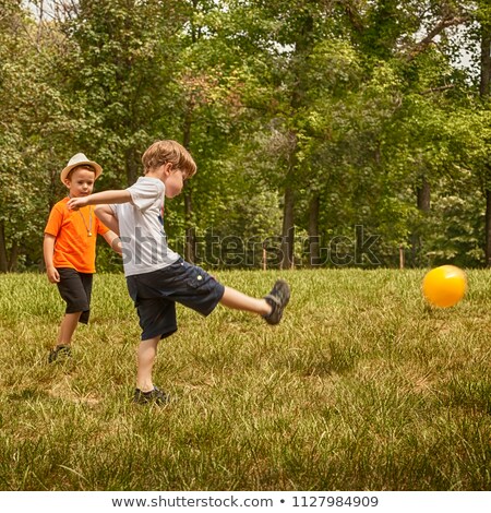 Stock fotó: Boy Kicking Soccer Ball Running Soccer Football Players Five Junior Footballers On Duel Football