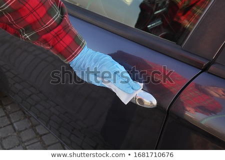 Stockfoto: Driver Cleaning Car Handle Using Antibacterial Solution And Clot