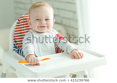 Stock foto: Young Child Eating In High Chair