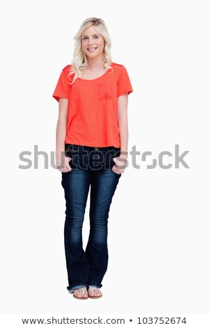 [[stock_photo]]: Smiling Fair Haired Standing With Her Thumbs In Her Pockets Against A White Background