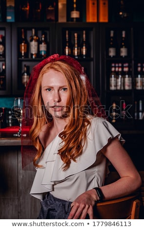 ストックフォト: Redhead Girl With Glass Of Wine In The Cafe