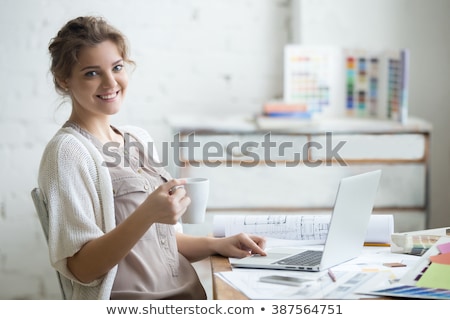 Foto stock: Young Woman Smiling In Pleasure Enjoying Coffee