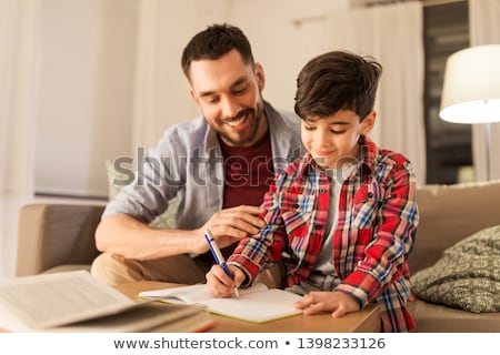 Foto stock: Schoolboy Studying In The Evening At Home