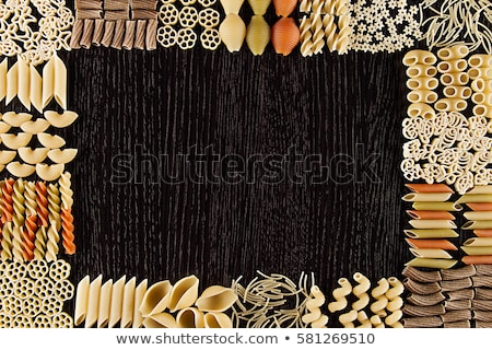 Foto stock: Assortment Italian Dry Pasta On Dark Brown Wooden Board With Blank Copy Space As Decorative Frame Ba