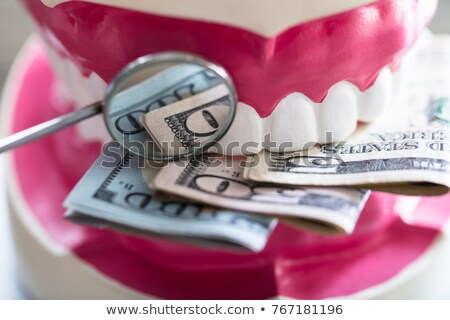 Foto stock: Close Up Of Denture With Banknote