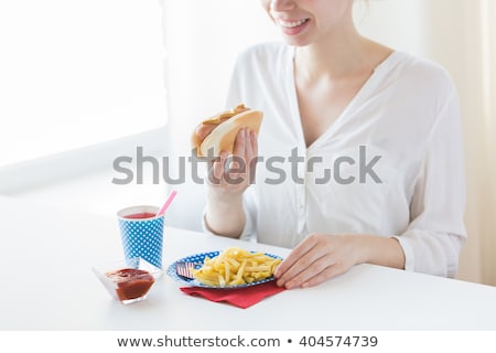 Stock photo: Close Up Of Woman Eating Hotdog And French Fries