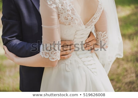 Foto stock: Tender Beautiful Brides Hands On Elegant White Wedding Dress Closeup