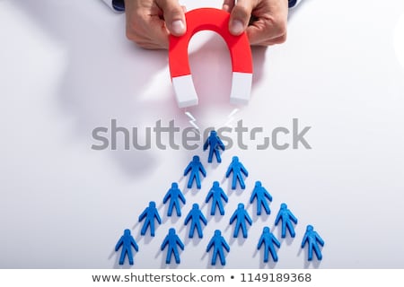 Foto d'archivio: Businessman Attracting Red Team With Horseshoe Magnet