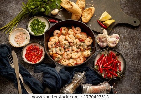 Foto d'archivio: Tasty Shrimp Tails Fried In Butter With Garlic Parsley White Wine Chili With Various Ingredients