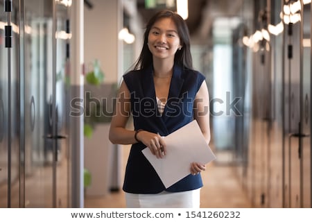 Foto stock: Smiling Banker Standing In A Hall