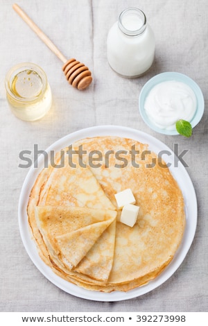 Foto stock: Thin Crepes Or Pancakes With Butter Honey And Sour Cream Top View Copy Space