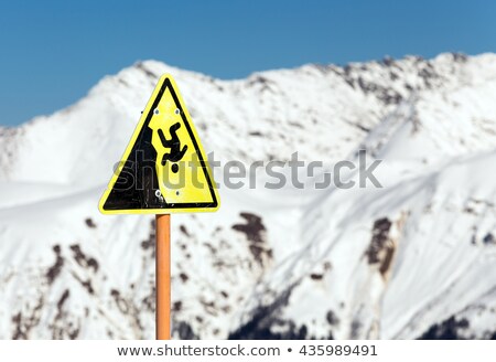 Stockfoto: Warning Sign - Possible Fall From The Mountain Cliff