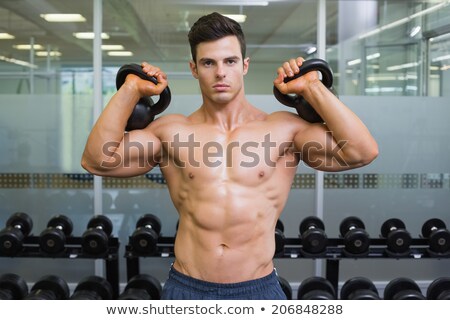 Stock photo: Man Lifting Kettle Bell Front On