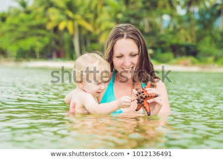 Сток-фото: Mom And Son Found A Red Starfish In The Sea