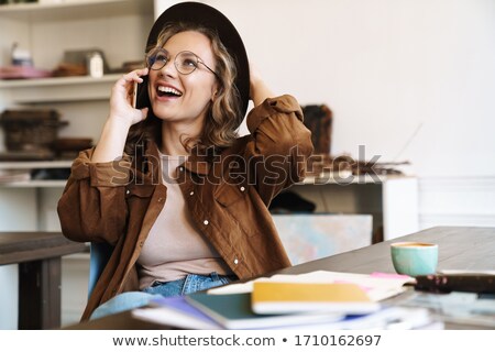 Stock fotó: Cheerful Young Hipster Woman Talking By Smartphone