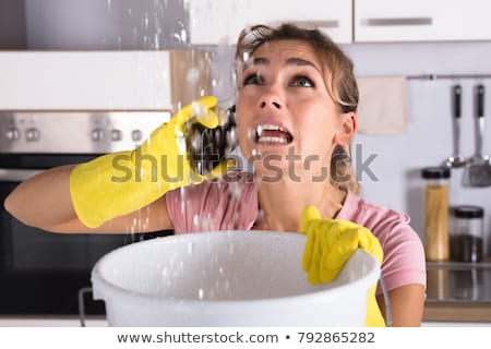 ストックフォト: Woman Collecting Leaking Water In Bucket