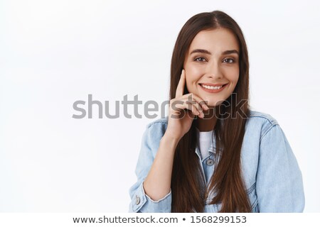 Stock photo: Close Up Portrait Of Pleased Attractive Brunette Woman Gazes Directly At Camera Keeps Hands Near Fa