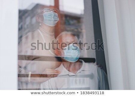Foto stock: Man Wearing A Surgical Mask In His Arm