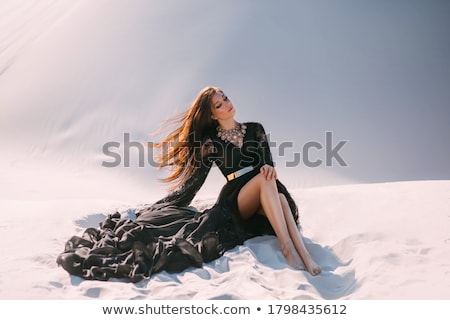 Foto stock: Fashion Brunette Woman With Long Legs Sitting On The Luxury Blac