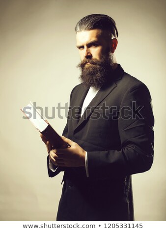 Stockfoto: Businessman In A Suit Holding A Book