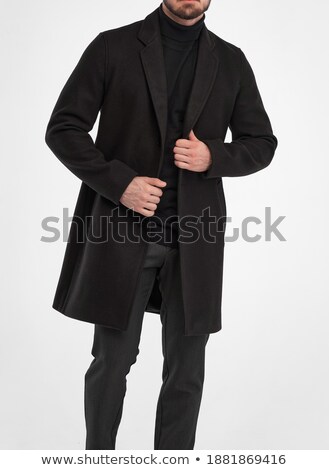 Stok fotoğraf: Handsome Young Business Man Wearing A Long Black Coat